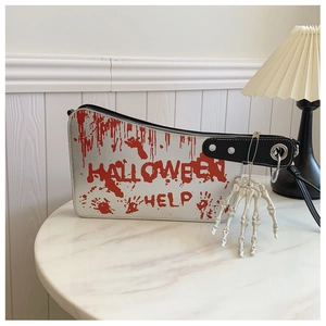 Detail of silver Halloween bag with red blood print, skull hand charm and metal rings