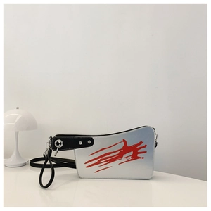 Detailed close-up of a creative cleaver shaped bag with realistic red splatter patterns