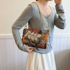 Ethnic style shoulder bag with floral embroidery, sequins, and gold chain strap