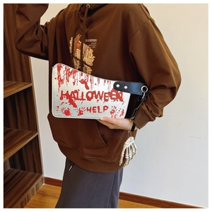 Close-up of bloodstained cleaver-shaped Halloween bag with skeletal hand charm and text