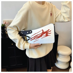 Quirky cleaver shaped white bag with red handprint art and black leather handles