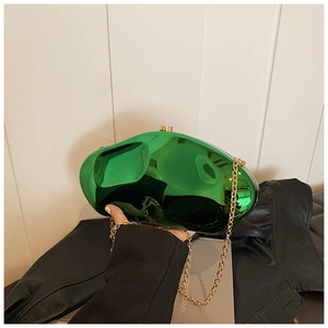 Macro detail of high-gloss green stone-shaped clutch bag with golden chain strap