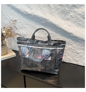 Detailed view of newspaper print tote bag with waterproof coating and reinforced handles