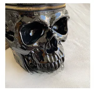Close-up of gloss skull round bag with premium gold zipper and mirror finish details