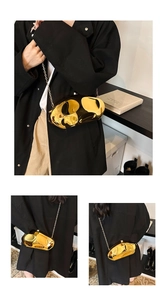 Close-up of gold mirror acrylic clutch bag with irregular fluid shape and chain strap