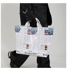 Detail of vintage newspaper print on a large tote bag with snowy mountain graphic accent