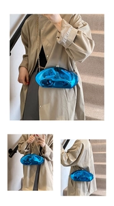 Detail of bright blue acrylic stone clutch with liquid metal mirror finish and gold chain