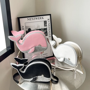 Cute dolphin-shaped crossbody bags in pink, white, and black with shiny glitter finish