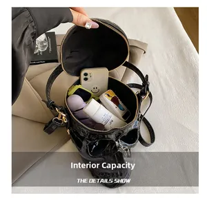Internal capacity of the black skull shoulder bag showing space for phone and accessories