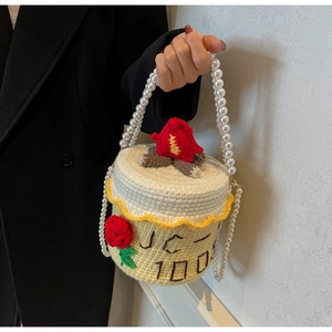 Détail d'un sac gâteau fait main au crochet avec chaîne en perles et broderie rose