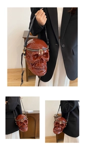 Detailed view of creative skull-shaped crossbody bag with glossy brown finish and gold zippers