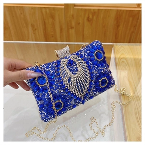 Close-up of sparkling blue rhinestones and silver crystal patterns on this luxury clutch