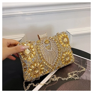 Macro view of gold evening bag with rhinestones and yellow gemstones on the surface