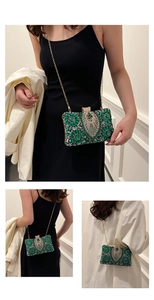 Detailed view of luxury emerald floral rhinestone evening bag with sparkling tassels