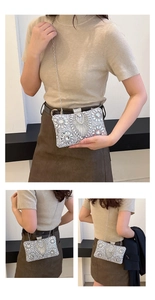 Close-up of sparkling silver rhinestone clutch with luxury fan-shaped pattern detail