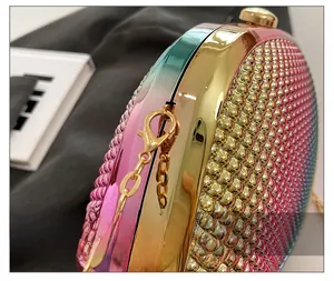 Close-up of luxury gradient shell clutch showing gold metal hardware and beaded texture