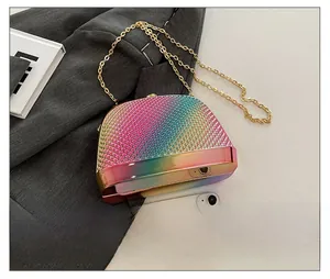 Rainbow gradient shell bag shown with smartphone to illustrate compact size and gold chain