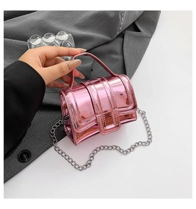 Detail of glossy metallic pink mini handbag with a detachable silver chain strap