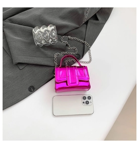 Top view of mini hot pink glossy patent leather crossbody bag with silver chain strap