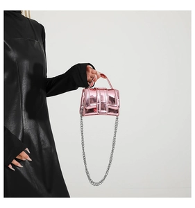 Detailed view of pink metallic mini crossbody bag with glossy finish and chain strap
