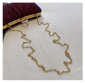 Detail of the elegant wine red pleated evening clutch with crystal ring clasp and gold chain