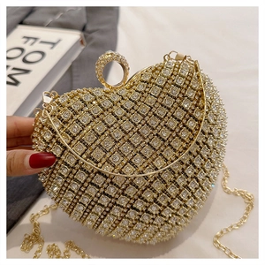 Detail of heart-shaped evening bag with sparkling rhinestones and gold ring clasp