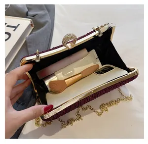 Detailed interior of purple sequin evening bag showing space for phone and makeup accessories