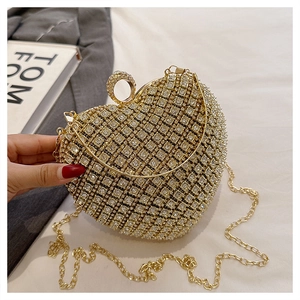 Macro shot of a heart-shaped evening bag with sparkling rhinestones and chain strap