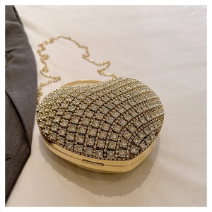 Detail of a luxury gold heart-shaped evening clutch bag with sparkling rhinestones