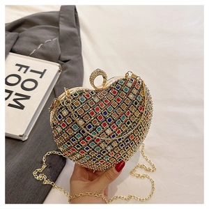 Detailed macro of a heart evening bag with colorful rhinestones and gold ring clasp