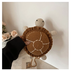 Detail of a handmade crochet turtle bag with brown shell and soft knitted texture