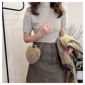 Detail of the sparkling multi-color rhinestone heart evening bag with chain strap