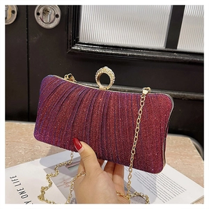 Detail of glitter evening clutch with gradient purple fabric and ring diamond clasp