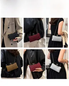 Detail of evening clutch bag showing multiple carrying styles with a metal chain strap