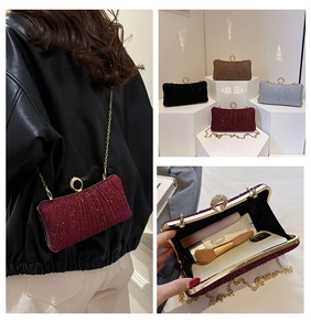 Detail of glitter clutch bags in four colors with crystal ring clasp and chain strap