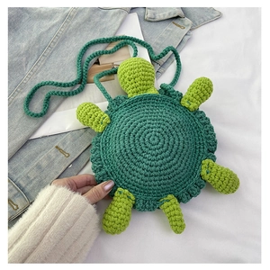 Macro detail of hand-knitted green turtle bag showing intricate spiral crochet textures