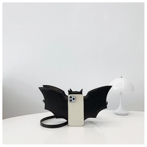 Detail view of the black bat-shaped PU bag with smartphone for size reference