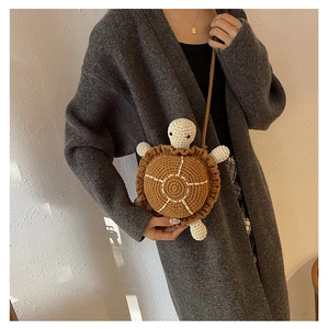 Close-up of handmade crochet turtle shoulder bag with intricate woven shell details