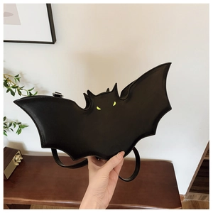 Detail view of the black bat-shaped PU leather bag with signature yellow eyes
