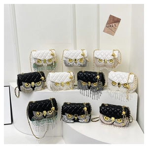 Detailed close-up of quilted chain bags featuring rhinestone owl eyes and fringe tassels