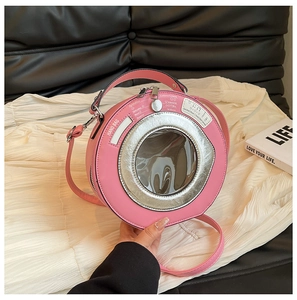 Detailed view of pink washing machine-shaped bag with a round window and shoulder strap