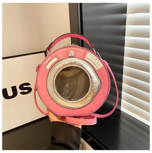Close-up of creative pink washing machine shaped handbag with metallic rim and clear window