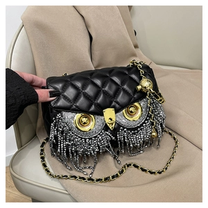 Close-up of owl-shaped shoulder bag with silver bead tassels and quilted leather details