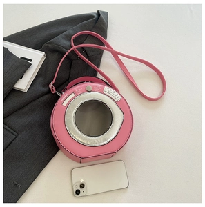 Detailed macro view of a pink washing machine shaped crossbody bag made of PU leather