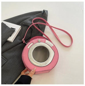 Detailed top view of pink washing machine shaped crossbody bag with adjustable strap
