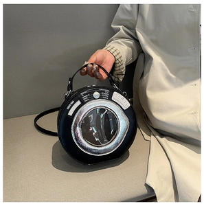 Detail of creative washing machine round handbag with metallic trim and PU leather