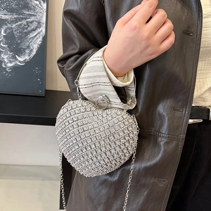 Elegant silver heart-shaped evening bag with sparkling rhinestones and chain strap