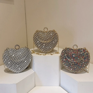 Sparkling heart shaped rhinestone evening bags in gold and silver with metal ring handles