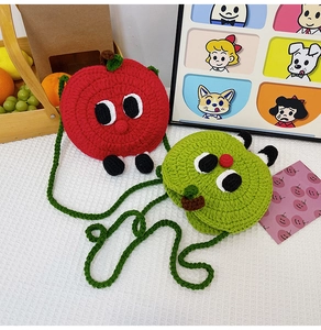 Detail of red and green handmade crochet apple coin purses with cute eyes and straps