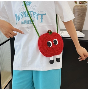 Cute red knitted apple shaped mini crossbody bag with cartoon eyes and green straps